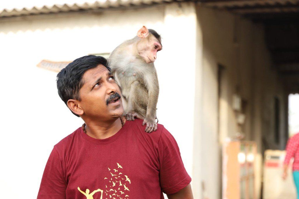 Founder of Panvatha bonding with a rescued monkey at the sanctuary